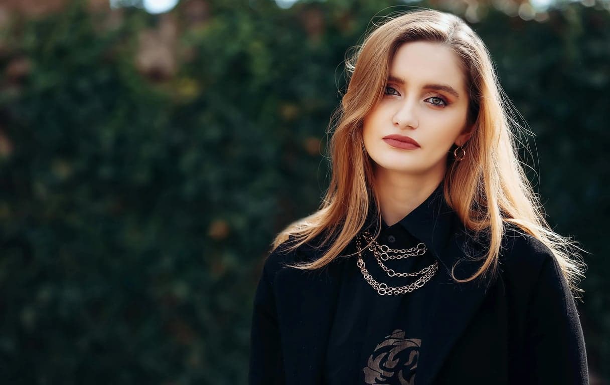 a portrait of a person with posture changed into a seated position on a chair, sitting upright but relaxed, spine naturally extended, shoulders open, feet grounded; hands resting casually on thighs or armrests; avoid rigid “formal sitting”; preserve proportions and identity; background remains unchanged