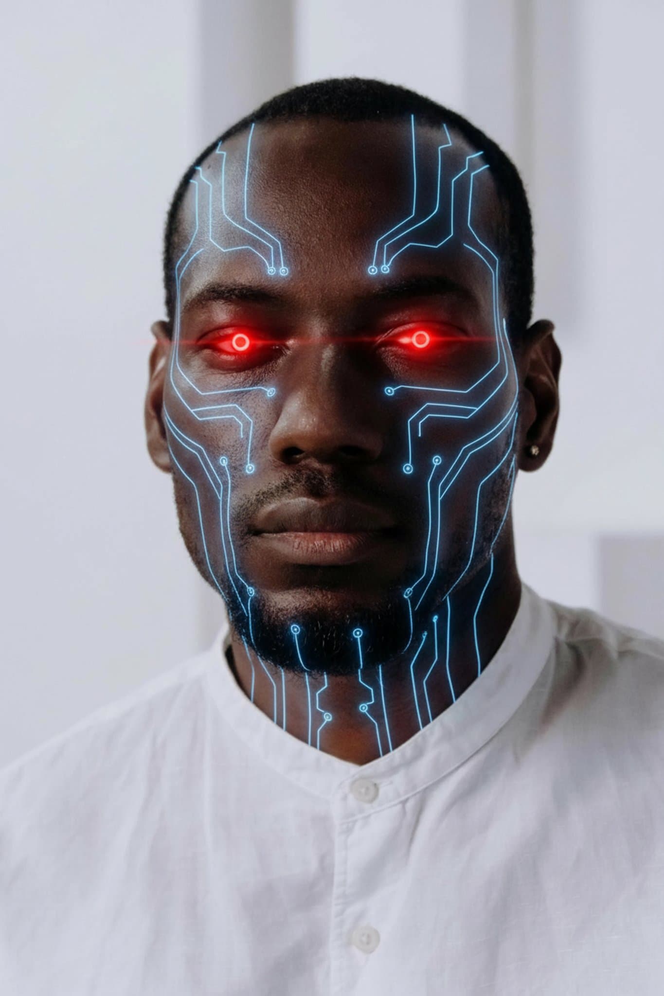 Portrait edited with glowing red robotic eyes and circuit board skin patterns.