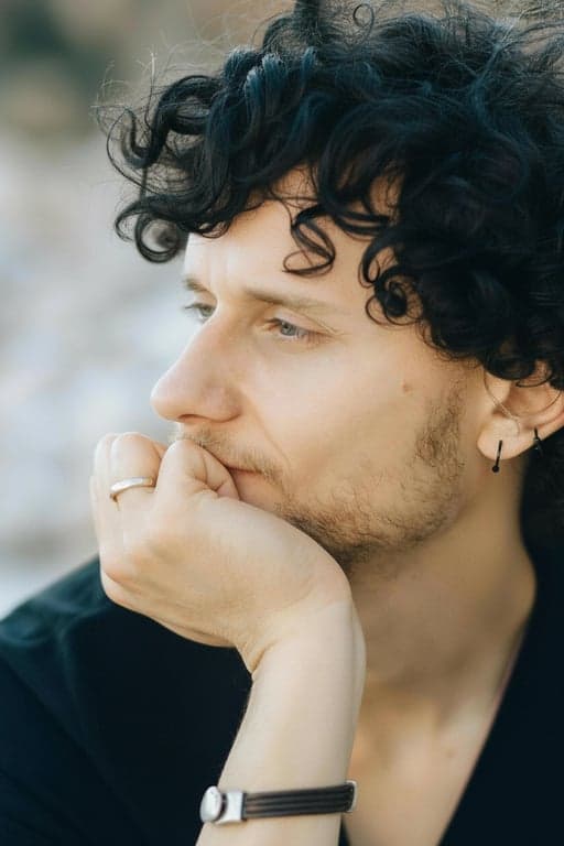 a portrait of a person styled with clean natural black hair and subtle reflective detail