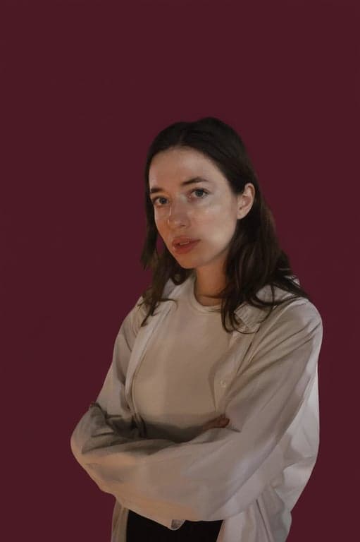 a portrait of a woman with the background changed to a rich burgundy color, evoking a sense of luxury and sophistication