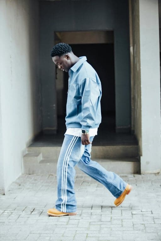 a portrait of a person enhanced with fashion styling that feels modern and approachable, smooth color balance, calm pose, and minimal backdrop