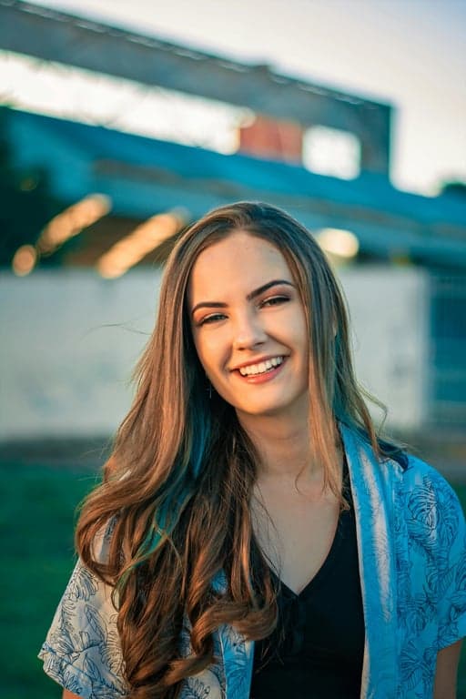 a portrait of a person styled with a modern shonen anime aesthetic, combining sharp facial features, muted tones, and cinematic darkness