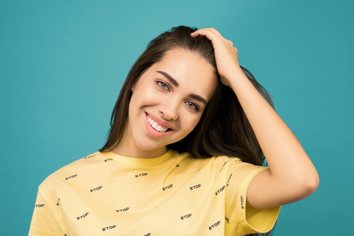 a portrait of a person transformed by pushing the hairline downward in a bold, obvious way, shortening the forehead and enhancing overall hair fullness and facial balance