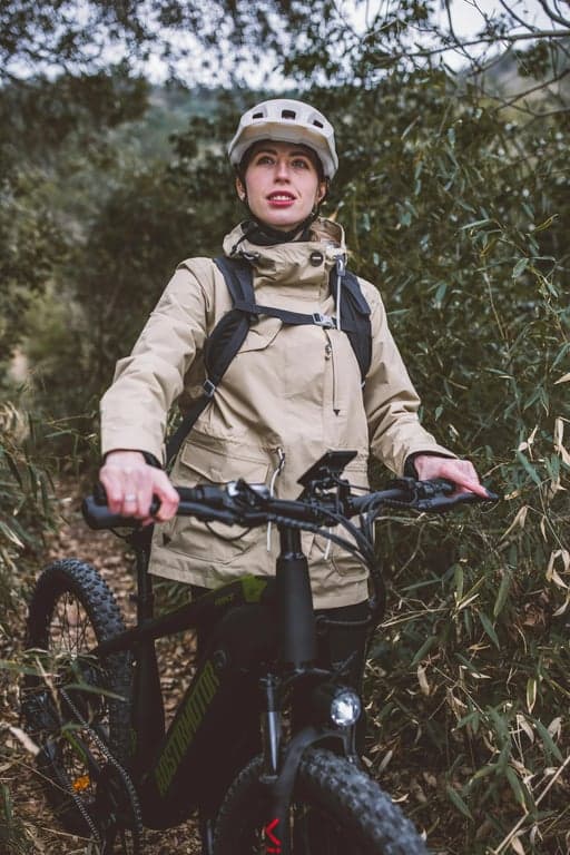 a portrait of a person engaged in an active hobby like hiking or cycling, captured candidly with natural sunlight and a genuine expression