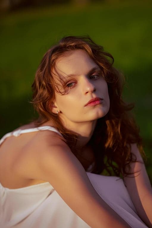 a portrait of a person with high-impact jawline sharpening that visibly alters the perceived face shape, creating a firmer lower facial outline and clearer jaw corner definition; keep jaw width and chin length unchanged; preserve skin pores and natural lighting; avoid extreme slimming or V-shape effects; do not modify background; result should look like a strong, realistic facial structure enhancement