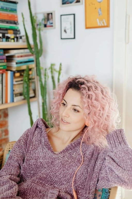 a portrait of a person edited to display soft pink hair tones with realistic root fade and even color distribution
