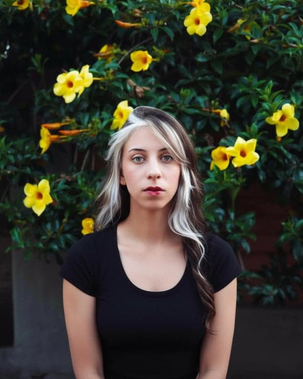 edit the image to create a dating app–ready profile photo by setting an eye-level perspective, correcting posture to look upright and relaxed, improving facial lighting to be soft and evenly distributed, removing harsh shadows under eyes and along the jaw, increasing facial clarity, subtly refining jawline definition without changing identity, simplifying the background, and ensuring the output is clearly more presentable than the original