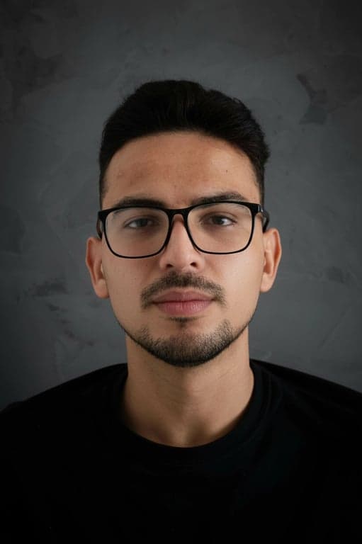 a portrait of a person edited with a face shape filter that gently refines the jawline, cheek contours, and face outline, slightly slimming the lower face, smoothing transitions between cheeks and jaw, maintaining original eye, nose, and mouth positions, preserving skin texture, natural expression, and consistent lighting