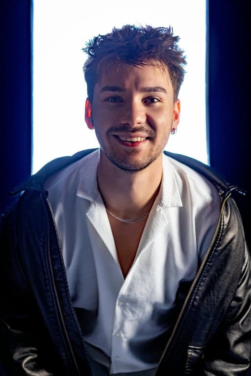 A psychedelic portal vortex in Rick and Morty title card style, with Morty falling into it screaming, his body distorted by the wavy rainbow colors, while Rick's hand reaches in from the edge of the frame to grab him.