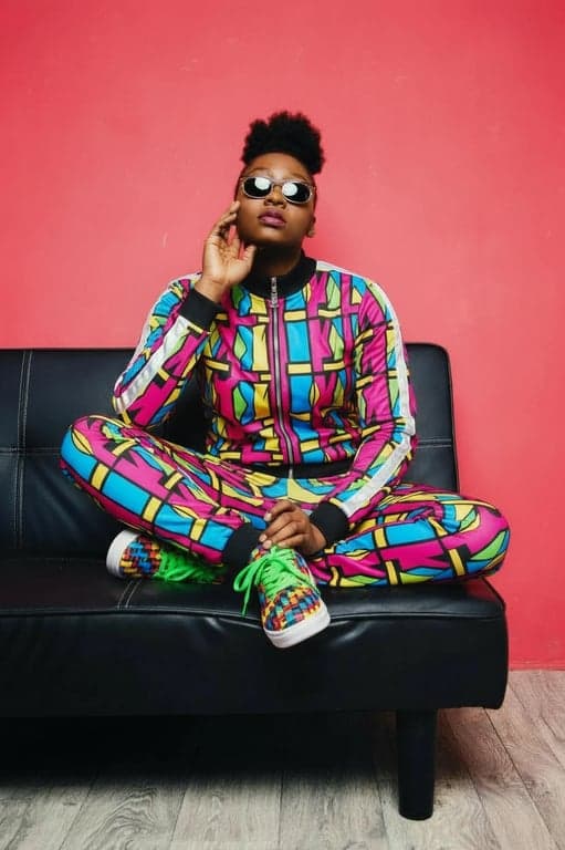 a portrait of a person with JoJo's signature muscular anatomy and flamboyant fashion, featuring bold patterns and sharp color contrasts