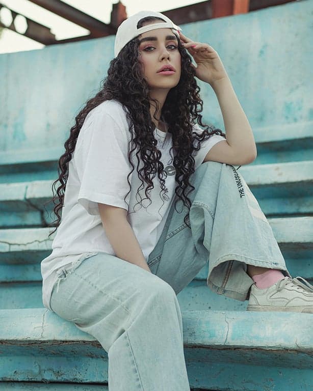 a portrait of a person transformed into a Polaroid-style instant photo with smooth tones, gentle haze, soft contrast, and subtle vignette