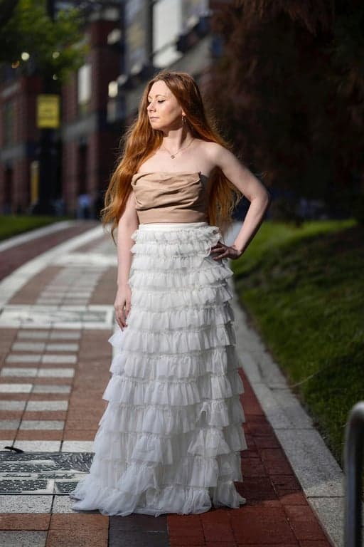 a portrait of a person transformed into an Attack on Titan–inspired anime illustration with realistic anime proportions, sharp angular facial features, muted earthy color palette, heavy shadowing, textured shading, and a serious war-like atmosphere