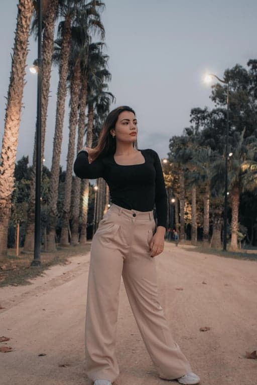 generate an online dating profile image by balancing exposure, removing dark areas around the cheeks and jaw, improving clarity of eyes and facial features, keeping realistic proportions and identity, reducing background clutter, and presenting a natural friendly expression, so the image feels trustworthy and clearly optimized for dating platforms