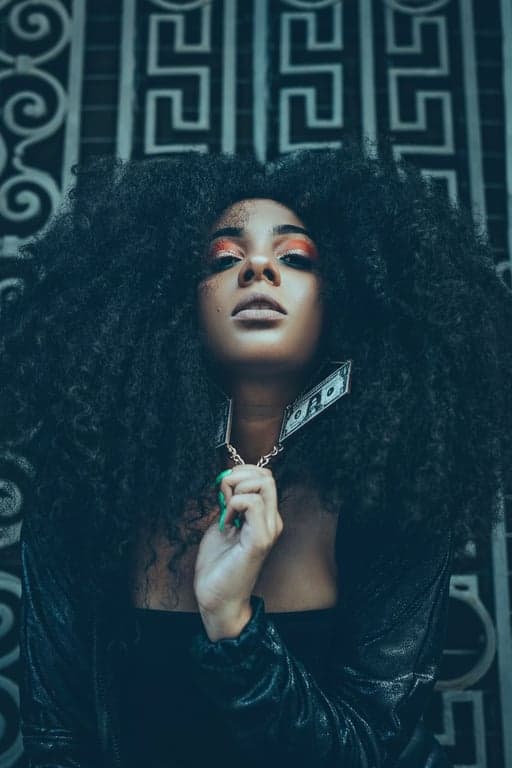 a portrait of a woman, icy blue tone filter, desaturated warmth, bright highlights, cool shadows, sharp clarity.