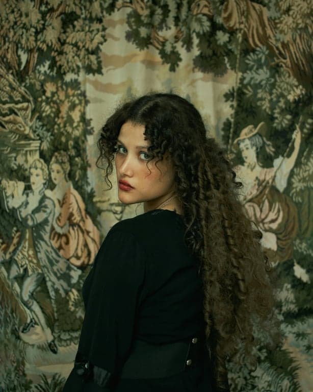 a portrait of a person converted into an Adventure Time-style cartoon character, emphasizing extreme simplification, flexible jelly-like anatomy, minimal facial detail, dot eyes, flat color blocks, thick hand-drawn outlines, and a quirky fantasy animation feel.