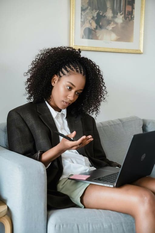 An AI-generated image showcasing a protective braided style with curly hair left out at the top, realistic blending, golden hour lighting, casual outfit.