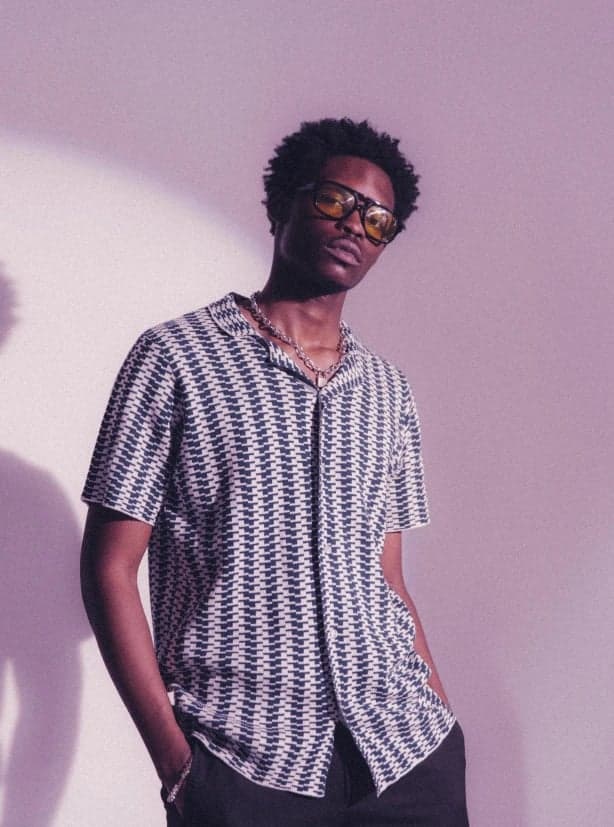 a portrait of a person enhanced with aesthetic outfit styling, smooth color transitions, fashionable simplicity, calm pose, and minimal backdrop