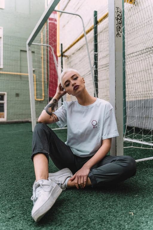 A cozy warm-toned indoor portrait of a woman, lamplight simulation, amber shadows, warm white balance, comfortable home environment.