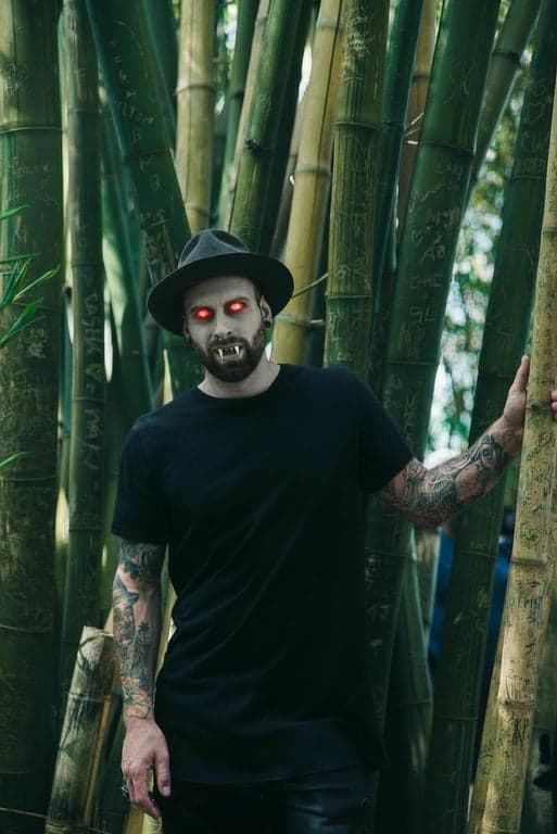 a portrait of a person as a vampire from the series, with pale skin, sharp fangs, and a chilling, supernatural presence