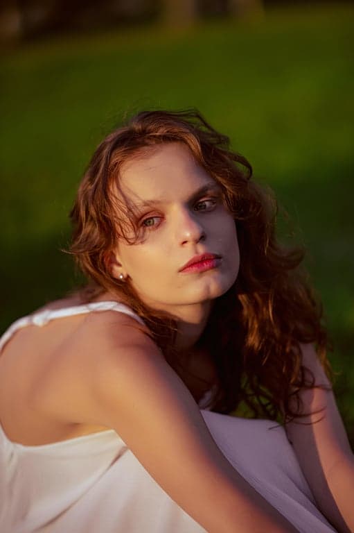 a portrait of a person with high-impact jawline sharpening that visibly alters the perceived face shape, creating a firmer lower facial outline and clearer jaw corner definition; keep jaw width and chin length unchanged; preserve skin pores and natural lighting; avoid extreme slimming or V-shape effects; do not modify background; result should look like a strong, realistic facial structure enhancement