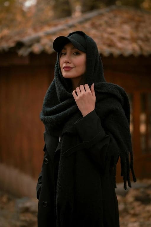 a portrait of a person with jawline refinement achieved through face-shape–aware contour enhancement, not geometry warping; reduce roundness in the lower face by sharpening the jaw edge and increasing contrast along the mandibular line; create a clearer break between jaw and neck to visually shorten the lower-face softness zone; keep cheeks, jaw width, and chin length consistent; preserve skin gradients and pores; maintain original background and lighting logic; the facial silhouette must look clearly more defined