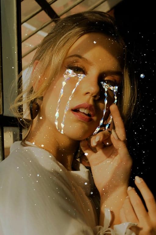 A creative filter that adds stylized, glistening crystal-like tears, not fully realistic but artistic, with a melancholic and beautiful fantasy vibe.