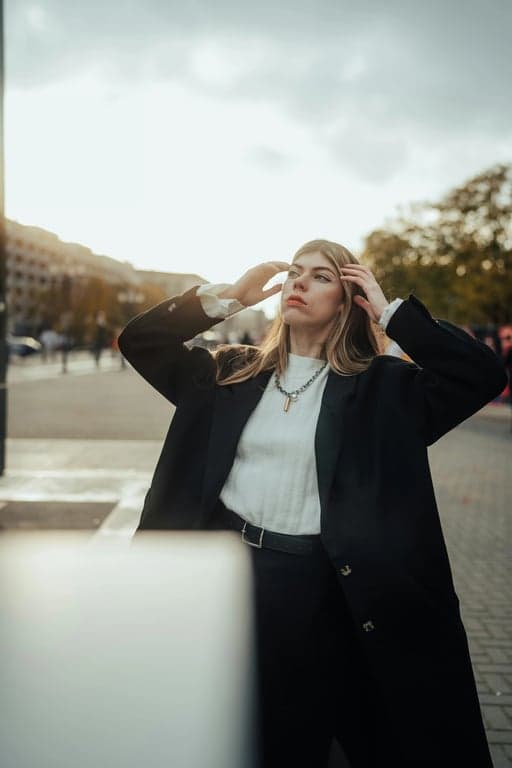 a portrait of a person styled as an anime sorcerer, wearing modern fitted clothing with clean silhouettes, dark tones, subtle highlights, and a composed confident posture