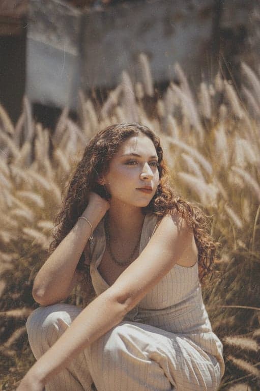 a portrait of a person transformed into an old film camera photo with grainy texture, muted saturation, and vintage softness