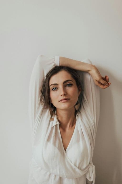 a portrait of a pregnant woman transformed into a vibrant color block maternity swimsuit, at a resort infinity pool