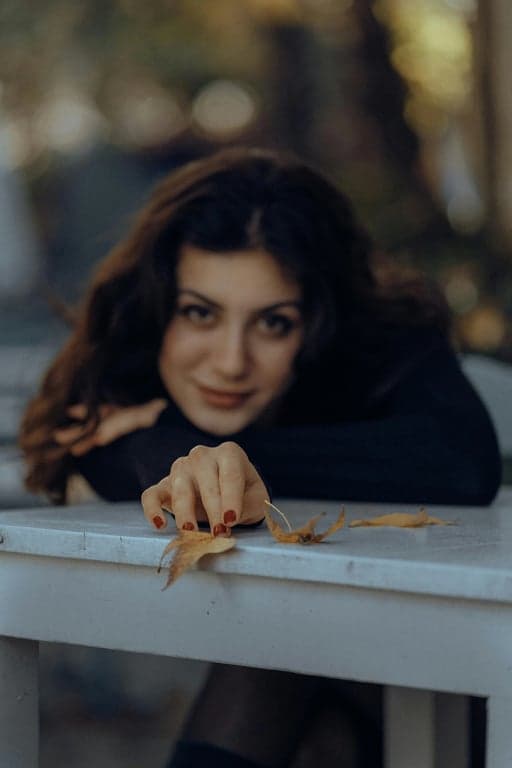 a portrait of a person edited to resemble a modern dark anime illustration, emphasizing sharp contours, minimal shading, and controlled lighting