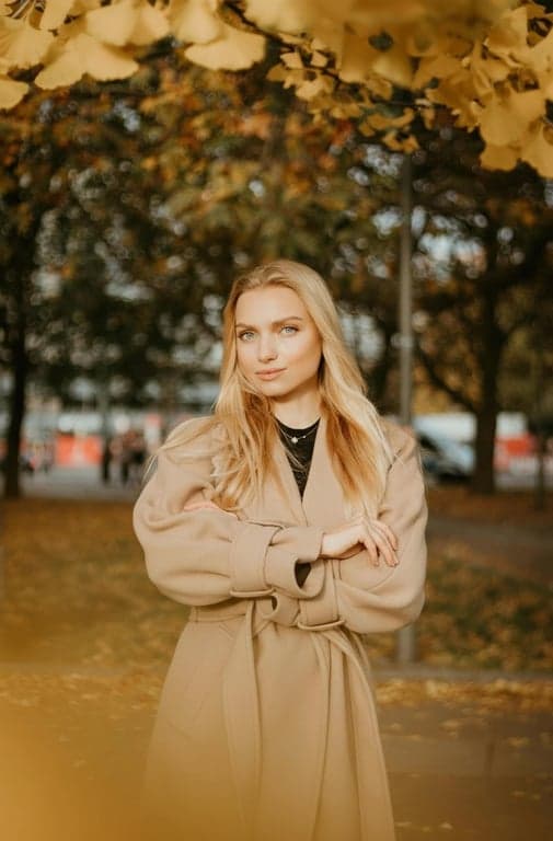 AI big eyes filter after photo - woman wearing a coat standing portrait after big eyes filter