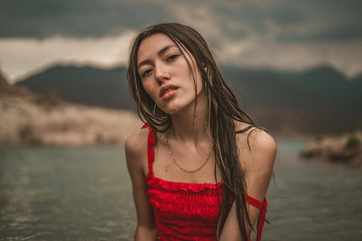 AI big eyes filter before photo - woman wearing red top