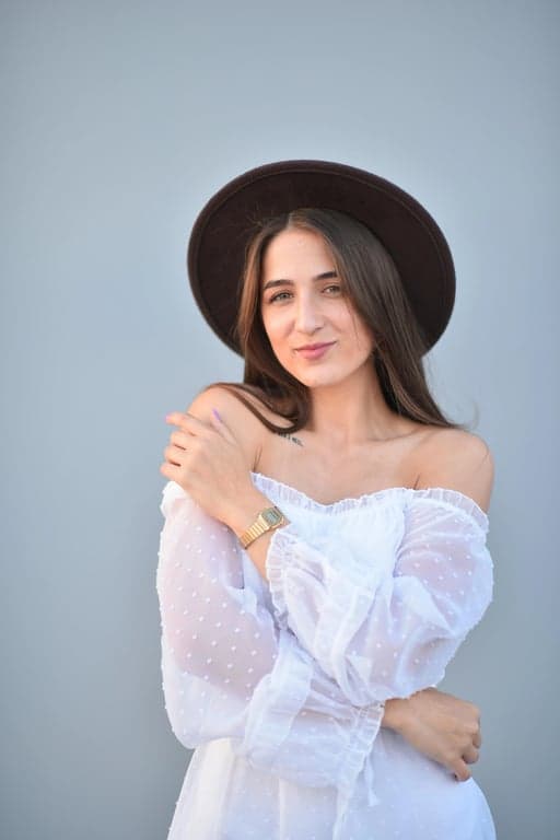 a portrait of a person transformed into a realistic T-shirt mockup with a simple logo-style design consisting of a small icon and short brand-like text beneath it, monochrome or two-color palette, clean vector-style edges, properly scaled to the chest area, and believable fabric behavior