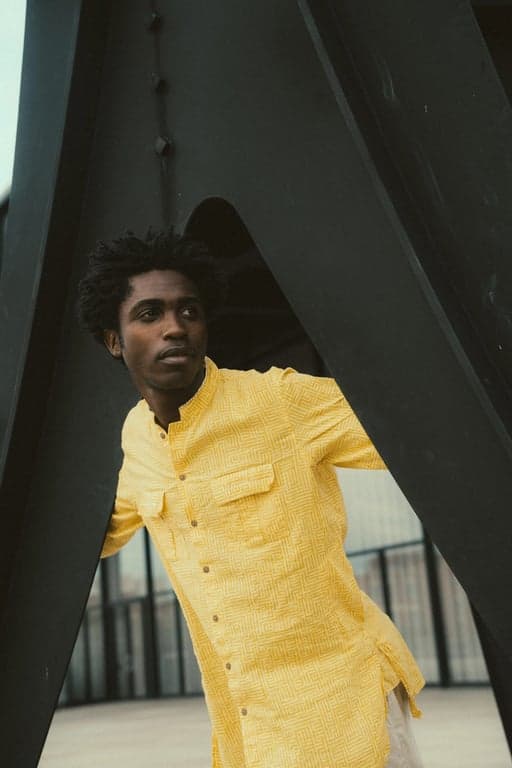 a portrait of a person styled with minimal aesthetic outfit elements, neutral color palette, simple fashionable clothing, composed posture, natural expression, soft even lighting, and uncluttered background