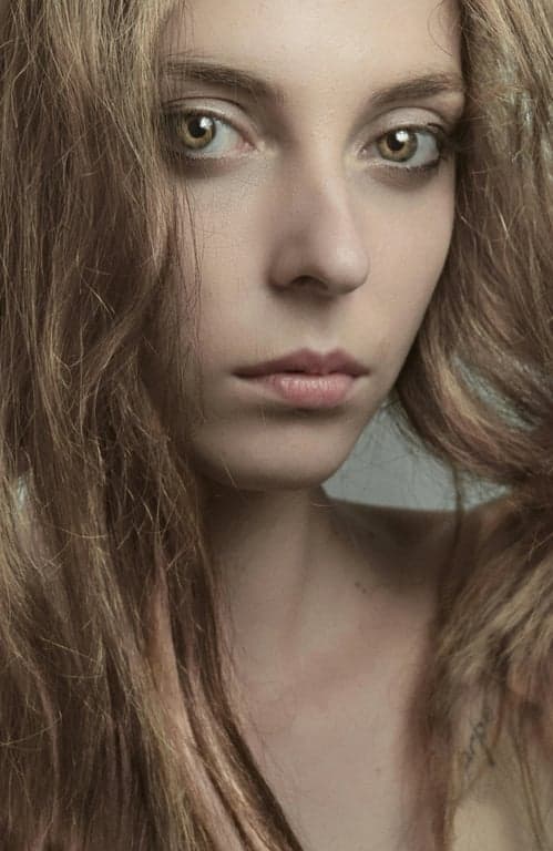 a portrait of a person edited to show silver-gray hair with metallic light response and preserved texture