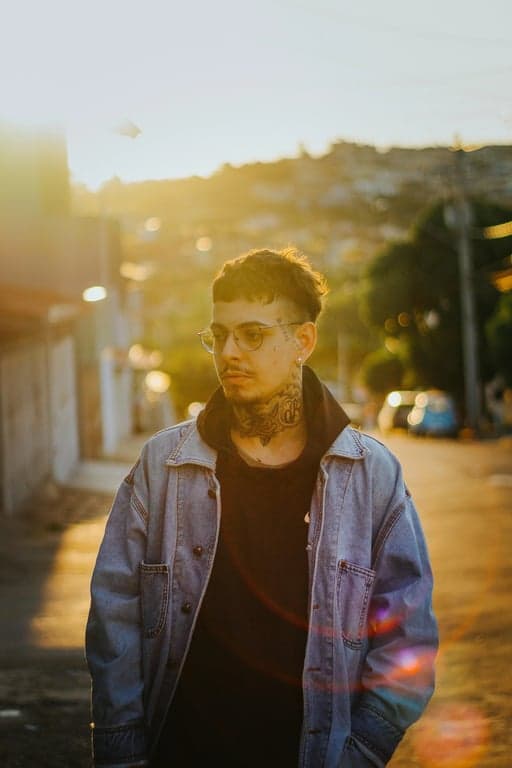 a portrait of a man edited in a Korean tidy short hairstyle style, so that the sides and back are cut very short close to the scalp following Korean barber techniques, while the top hair is short to medium length and straight, with no fringe, no curls or waves, and unchanged face and original lighting