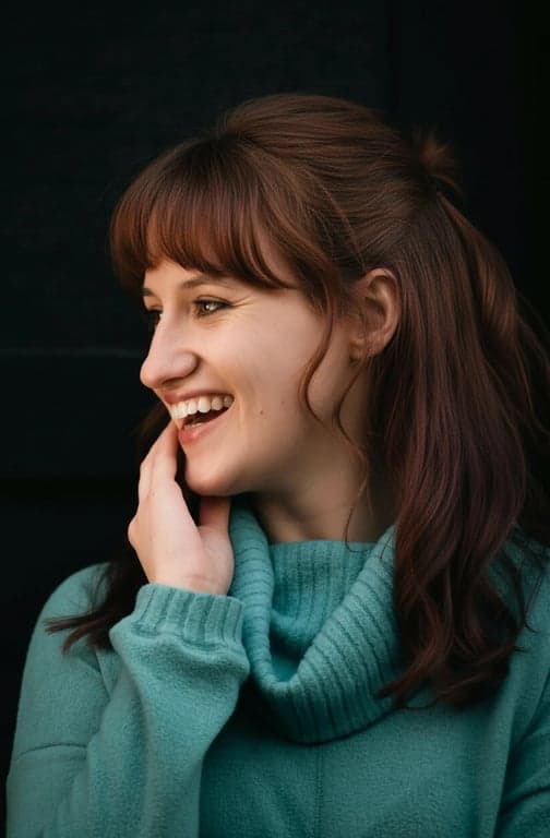 a portrait of a person with the hairline shifted noticeably downward, reducing a high or wide forehead and making the overall face appear smaller and more balanced with fuller hair framing the face