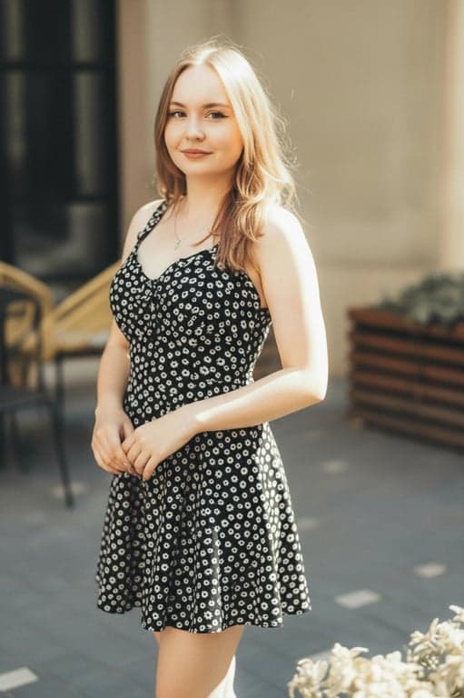 a portrait of a person with posture reconfiguration focused on body language rather than alignment: change pose to a comfortable standing or seated position that communicates openness, confidence, and ease; preserve body proportions and identity; keep background unchanged; result should look like a naturally different pose, not a subtle correction