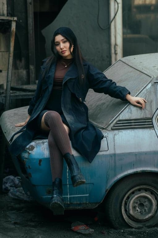 a portrait of a person edited to improve jaw-to-neck separation by redefining the lower facial silhouette, making the jawline appear straighter and more continuous; deepen submental shadow to compress visual fullness beneath the chin; maintain original bone structure and proportions; preserve natural complexion and texture; ensure lighting consistency; do not alter the background; the resulting face shape should appear sharper and more sculpted without looking reshaped