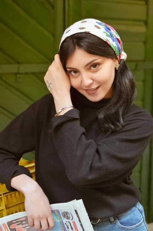 a portrait of a person transformed into a shoujo anime style illustration with thin delicate linework, rounded facial contours, large gentle eyes with visible lashes, soft blush on cheeks, subtle nose and mouth, pastel color palette, and clean light anime shading