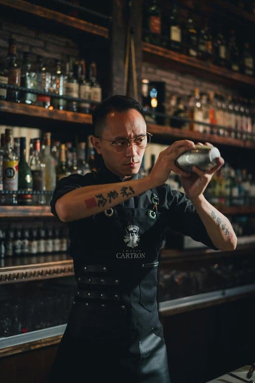 a portrait of a person illustrated in an Adventure Time-inspired animation style with intentionally awkward proportions, soft rounded shapes, noodle arms, stubby legs, simplified face design, flat colors, uneven outlines, and a lighthearted surreal cartoon mood.