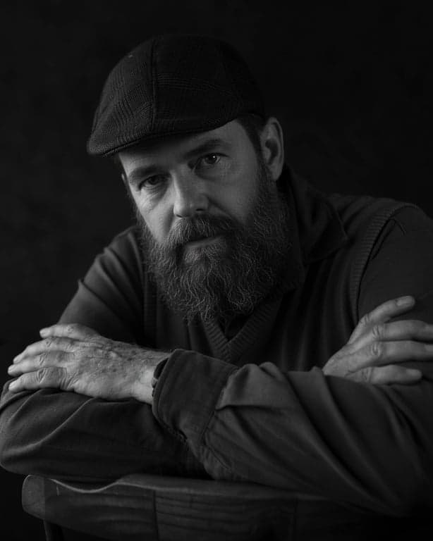 age ai generator after photo - the same man crosses his arms in his 30s