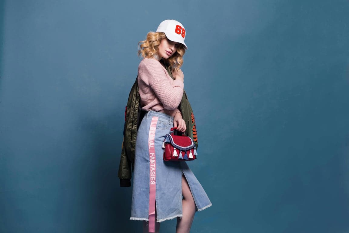 a portrait of a woman in a sparkling diamond-encrusted party top with champagne tones and festive celebratory lighting