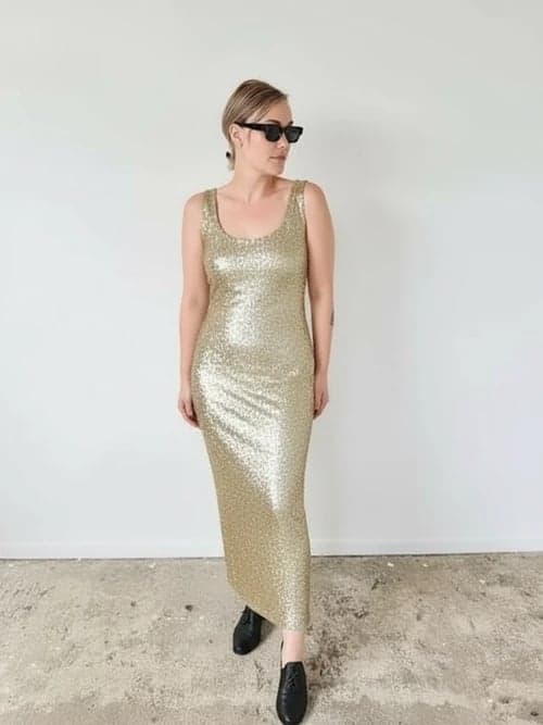 Christmas outfit after – person in a glitter cocktail dress under festive lights