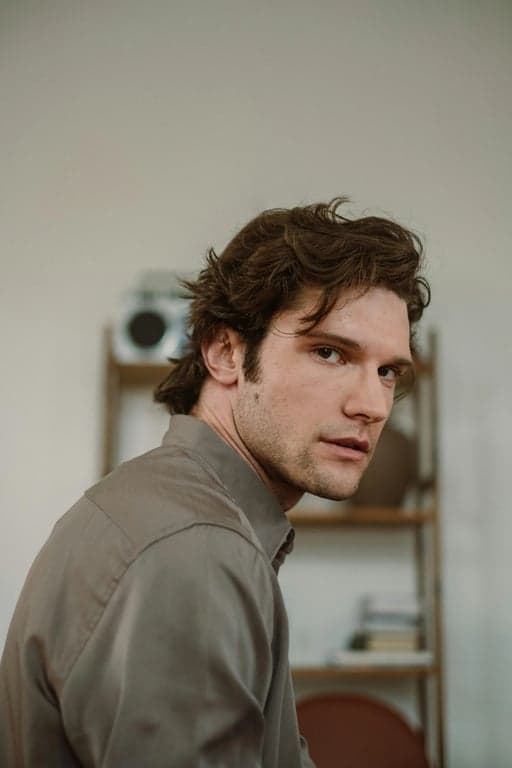 a portrait of a person styled as an anime hero with dynamic lighting, bold outlines, controlled color blocking, energetic expression, and simplified anime background elements