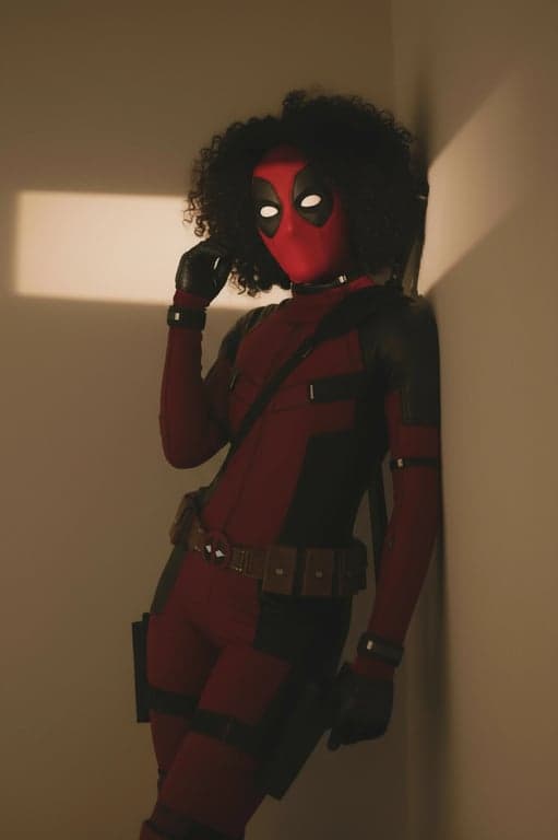 a portrait of a person edited as a female version (Lady Deadpool) cosplay, adapting the red suit with feminine cuts and styling