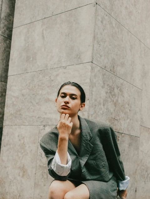 a portrait of a person styled with an energetic anime hero look, focusing on expressive eyes, strong outlines, vivid tones, and youthful power