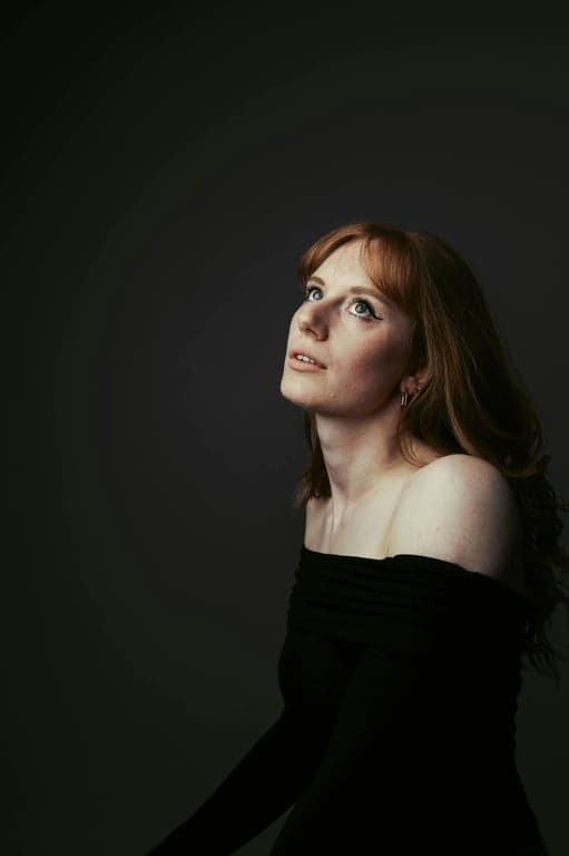 a portrait of a person reimagined in a retro camera style with reduced clarity, uneven tones, and nostalgic imperfections