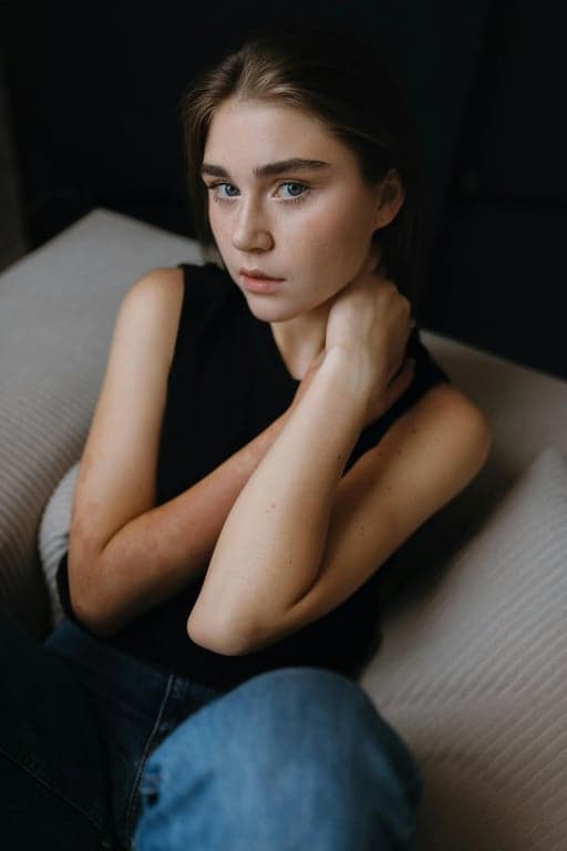 a portrait of a person in a Korean street-editorial look featuring clean-cut coat, subtle layering, straight silhouette, neutral tones, precise proportions, confident walking posture, natural daylight