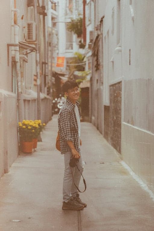 a portrait of a person enhanced with old camera aesthetics, featuring inconsistent exposure, subdued highlights, rough grain, and a worn photographic feel